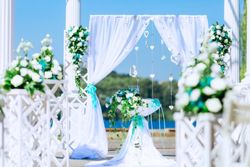 arch for the wedding ceremony with tulle and table with bouquet