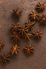 Brown textured background with anise stars
