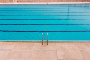 Swimming Pool.swimming pool bottom caustics ripple and flow with waves background.Swimming pool of luxury hotel. Blue water and laens in swimming pool.