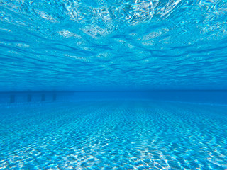 Transparent clear water in the pool. Underwater photo of the regulatory pool. Blue water pool...