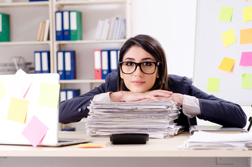 Young female employee in conflicting priorities concept 