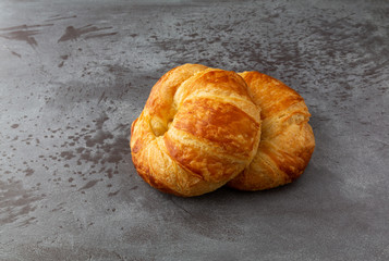 Fresh croissants on a gray background side view