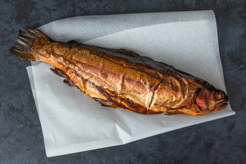 Smoked trout fish on a dark background