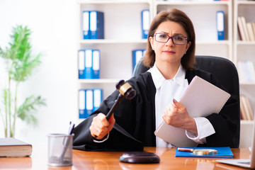 Middle-aged female doctor working in courthouse 