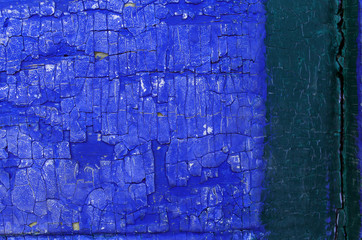 Old wooden background with remains of pieces of scraps of old paint on wood. Texture of an old tree, vintage wood background peeling paint. old blue board with cracked paint