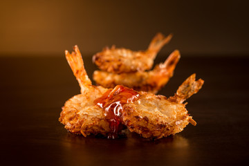 Fried shrimp with sauce in a dark ambient