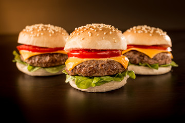 Three mini burgers in a dark ambient