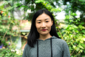 Chinese woman inside a tropical greenhouse