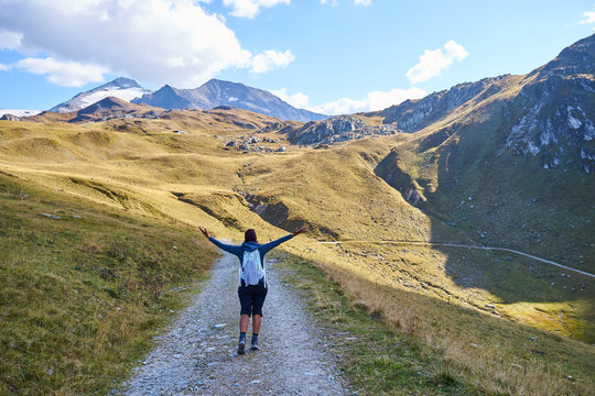 Woman hiking on a trail in the valley "Weitental" in the Alps of Tux in Austria