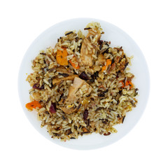 Chicken with pecans and wild rice on a plate isolated on a white background