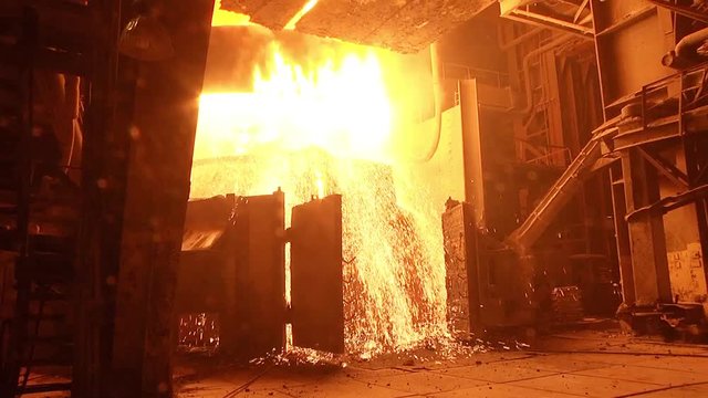 Molten steel pouring in ladle. Molten metal transporting from ladle for casting.