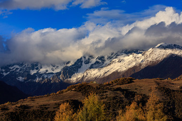 Four Girls Mountain National Park near Xiaojin, Sichuan Province China. Yaomei Peak Scenic Area, blue sky and clouds. Golden Fall Colors, Yellow Tree Leaves, Mount Siguniang, Hiking Destination