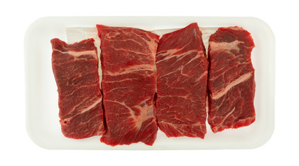 Beef chuck boneless short rib steak on a white foam tray