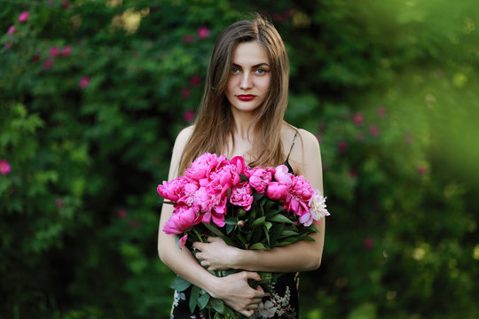 girl in the field of flowers. portrait of a girl with pink flowers