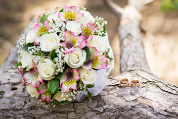 Wedding background bouquet and rings on wood. declaration of love. Wedding card, day details