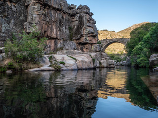 Fototapeta na wymiar Nature landscape, river passing under an ancient bridge