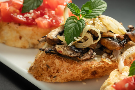 Fresh bruschetta assorted. Serve on a white plate. Order in the menu
