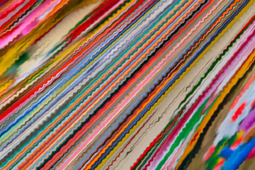 Abstract background of many vibrating colored stripes.