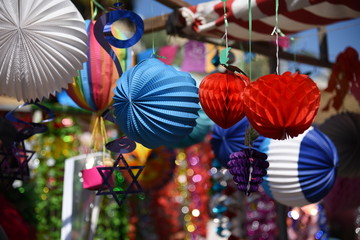 Fototapeta na wymiar Colorful sukkah decorations. Sukkoth four species festival. Shimmering decorations for party.