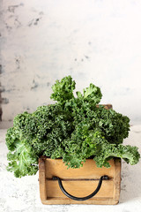 Fresh green kale in a wooden box