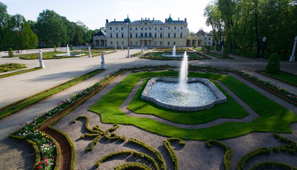 Aerial view of beautiful palace garden with sculptures and perfectly trimmed bushes.