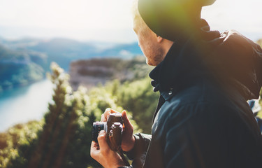 hipster tourist hold in hands taking photography click on retro vintage photo camera in auto, photographer looking on camera technology, hobby content mountain, panoramic landscape vacation concept