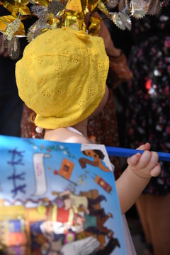 Colorful sukkah decorations. Sukkot four species festival. Shimmering decorations for party. Kid with flag. Simchat Torah