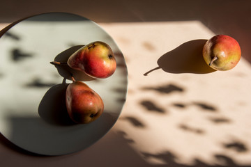 Pears still life with romantic shadows on the table in the morning sun. Minimal style with with...