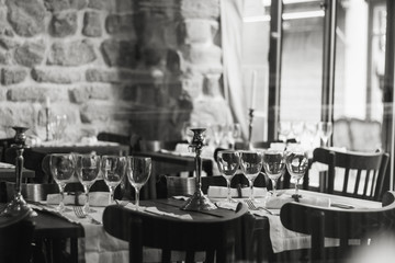 Table settings in a French restaurant. View through a window from a street.