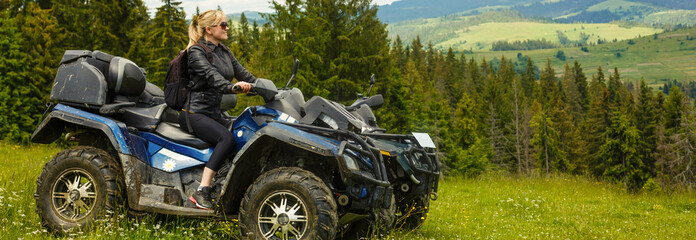 Young Woman Riding Quadbike On Lonely Field Against Sky. © Angelov