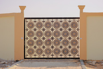 Close up of a beautiful pattern of metal main gate of a villa