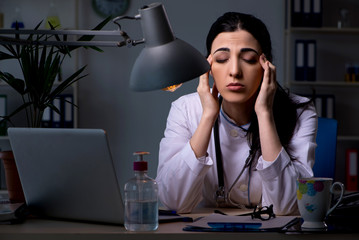 Young female doctor working at night shift 