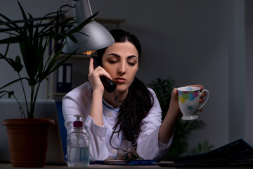 Young female doctor working at night shift 