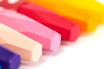 Group of crayons (pencils) stacked on white background
