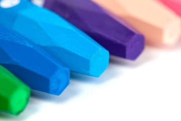 Group of crayons (pencils) stacked on white background