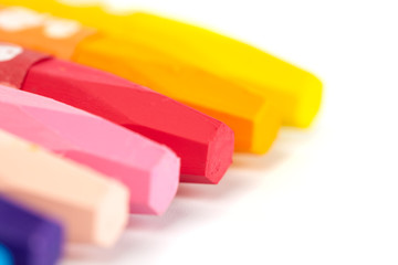 Group of crayons (pencils) stacked on white background