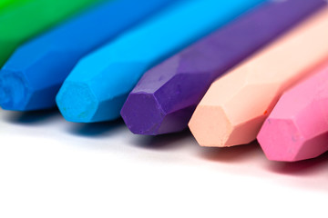 Group of crayons (pencils) stacked on white background