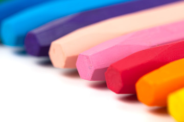 Group of crayons (pencils) stacked on white background