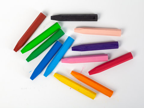Group of crayons (pencils) stacked on white background