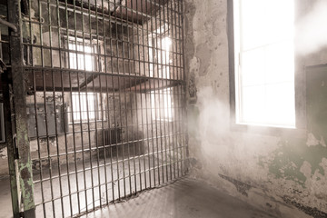 Bars in a Prison with windows to the outside and mist coming in