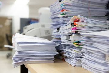 Business and finance concept of office working, Pile of unfinished documents on office desk, Stack...