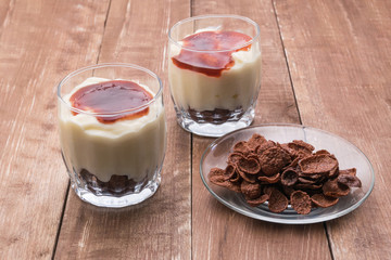 Yogurt with jam and cornflakes with chocolate.
