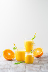 Fototapeta na wymiar Detox diet concept: orange smoothie on table