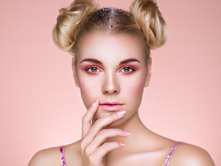 Blonde Girl with Elegant and shiny Hairstyle. Beautiful Model Woman with Curly Hairstyle. Care and Beauty Hair products. Nails and Manicure. Hair Curled into a Bun