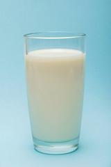 glass of milk on blue background