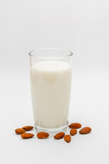 glass of almond milk on white background