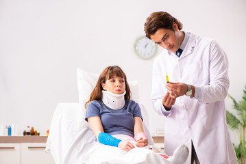 Young doctor examining injured patient 