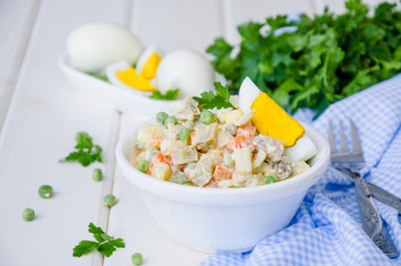Russian traditional salad Olivier with vegetables and meat