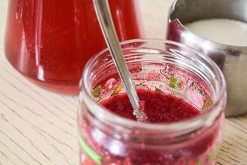 Compote, jam and sugar bowl. Glass and iron dishes with food on the kitchen table.