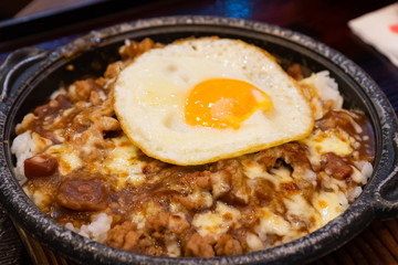 Japanese and Thai fusion food with fried egg on top.